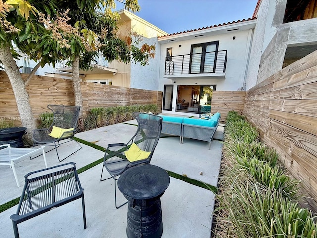 view of patio featuring an outdoor hangout area and a balcony