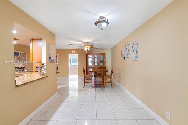 dining space featuring light tile patterned flooring and ceiling fan