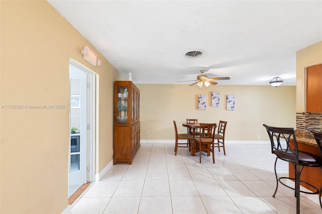 dining room with ceiling fan and light tile patterned flooring