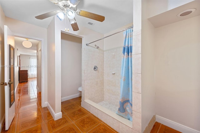 bathroom with toilet, tile patterned floors, and walk in shower