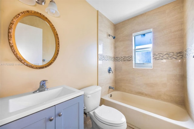 full bathroom with vanity, tiled shower / bath, and toilet