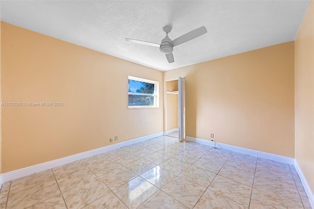 spare room with ceiling fan and a textured ceiling