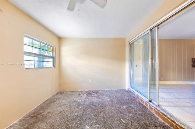 spare room featuring ceiling fan and carpet floors