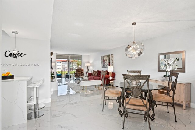 dining space with an inviting chandelier