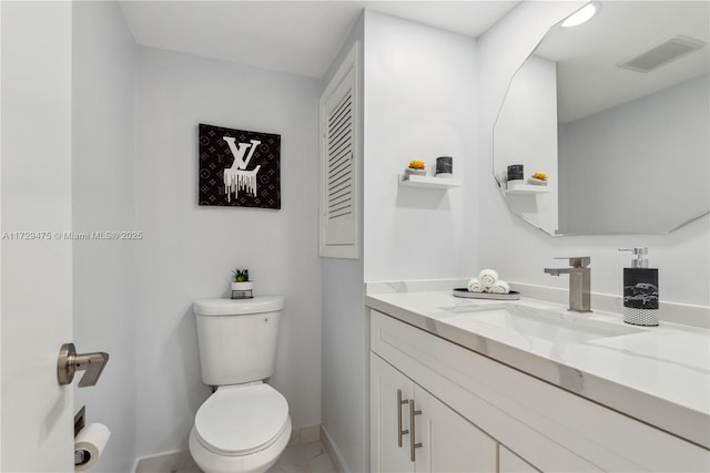 bathroom featuring vanity and toilet