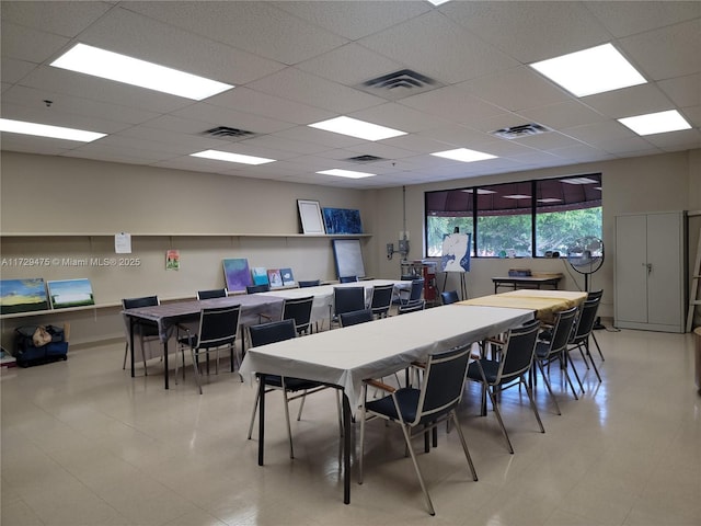 dining area featuring a drop ceiling