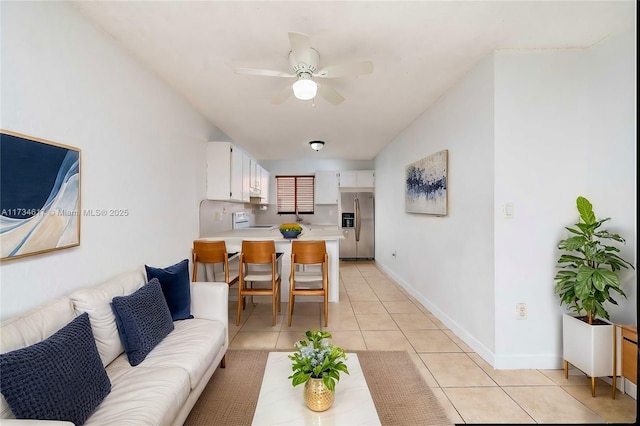 living room featuring light tile patterned floors and ceiling fan