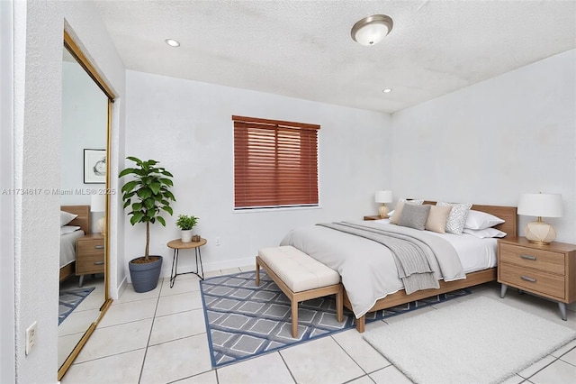 tiled bedroom with a textured ceiling