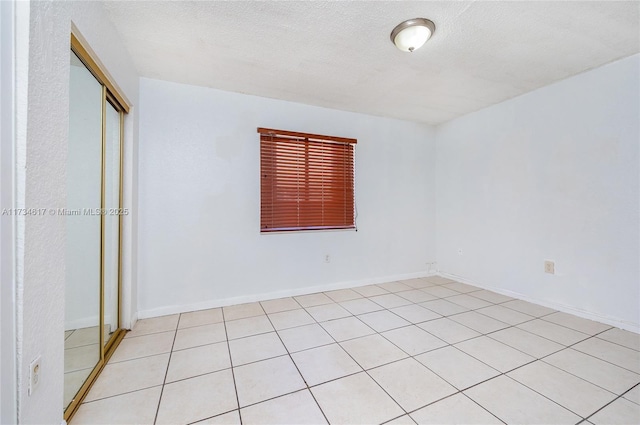 unfurnished room with a textured ceiling