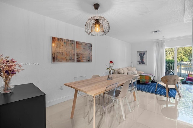 dining area featuring light tile patterned flooring