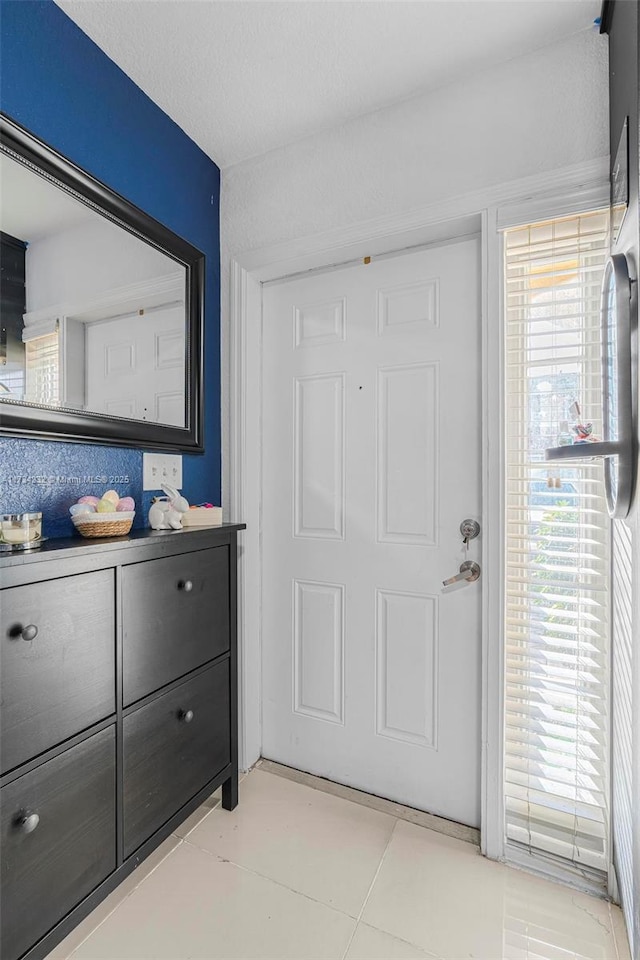 interior space with light tile patterned flooring and plenty of natural light