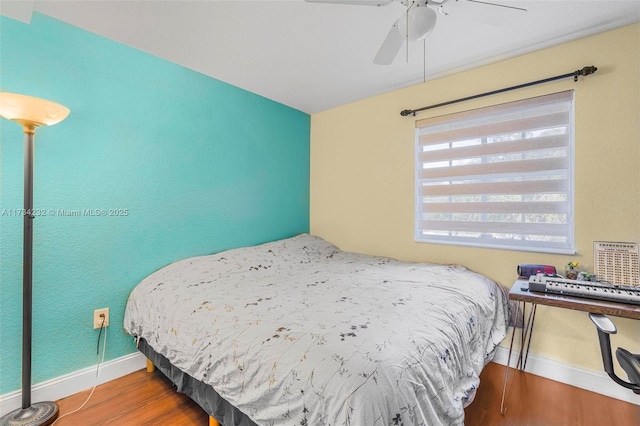 bedroom with wood-type flooring and ceiling fan