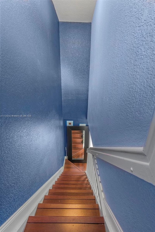 staircase featuring hardwood / wood-style flooring