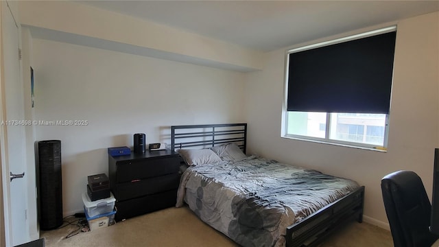 bedroom featuring light carpet