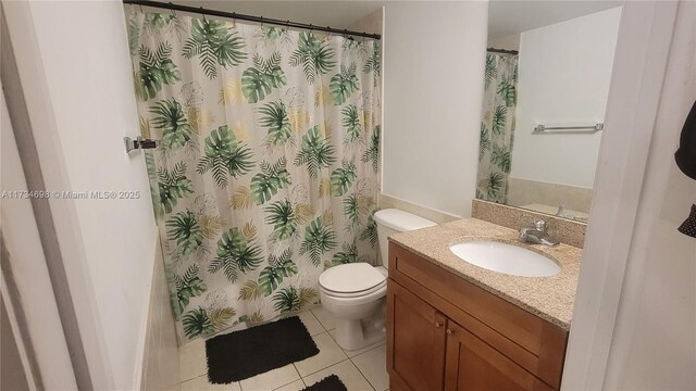 bathroom featuring tile patterned floors, toilet, and vanity