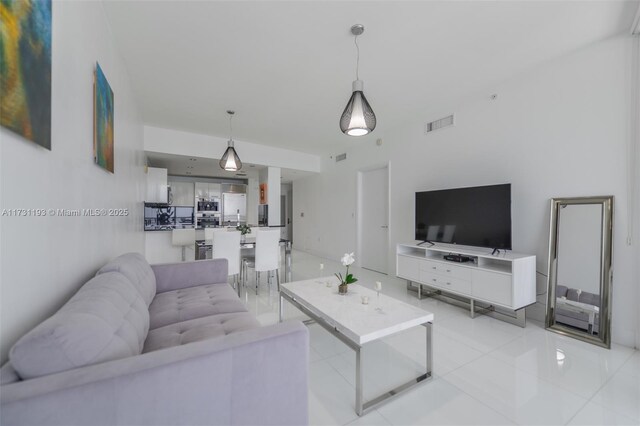 living room featuring a wall of windows and light tile patterned flooring