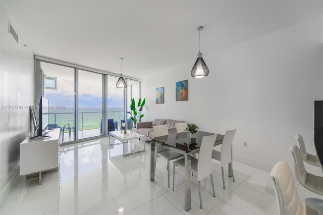 tiled living room featuring expansive windows