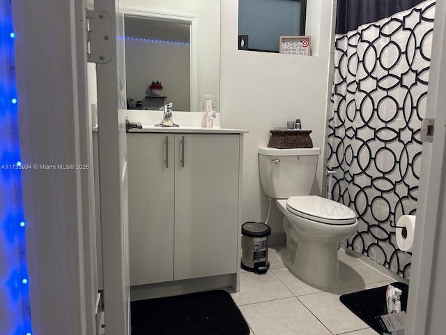 bathroom with tile patterned flooring, a shower with curtain, vanity, and toilet