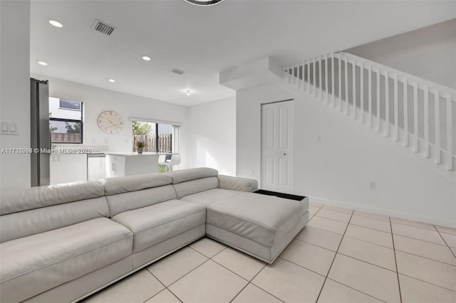 living area featuring baseboards, light tile patterned flooring, visible vents, and recessed lighting