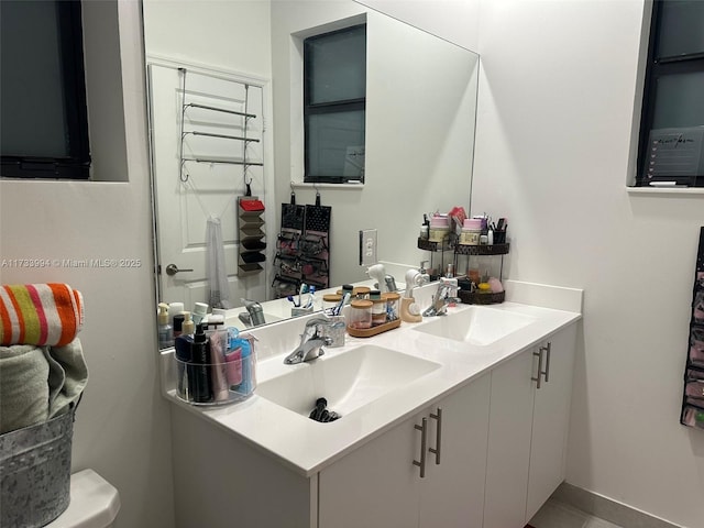 full bathroom featuring double vanity and a sink