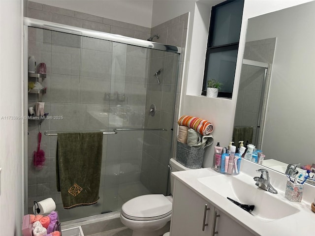 full bath featuring a shower stall, toilet, and vanity