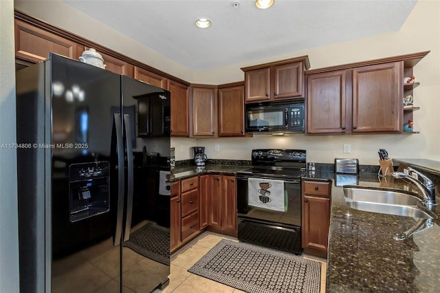 kitchen featuring light tile patterned flooring, dark stone countertops, sink, and black appliances