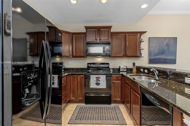 kitchen with sink, light tile patterned floors, dark stone countertops, ornamental molding, and black appliances