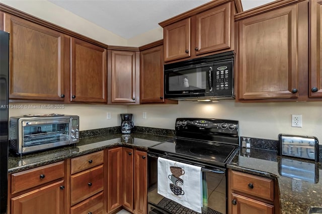 kitchen with dark stone countertops and black appliances