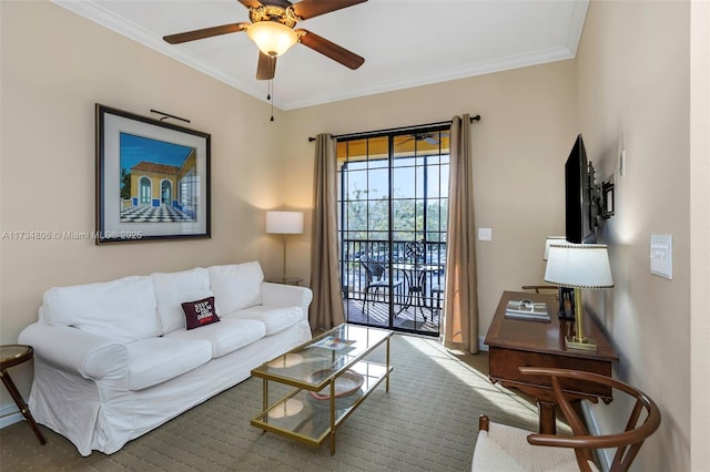 living room with ornamental molding and ceiling fan