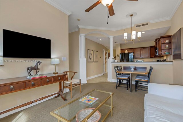 living room featuring crown molding, ceiling fan, and ornate columns