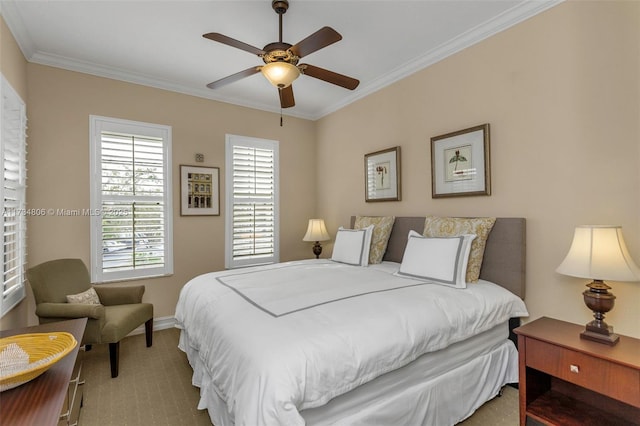 carpeted bedroom with ceiling fan and ornamental molding