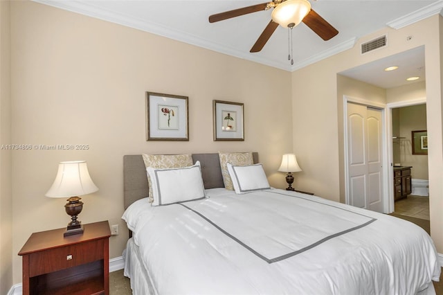 bedroom featuring ensuite bath, ornamental molding, and ceiling fan