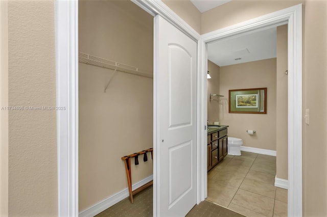 bathroom featuring vanity, tile patterned floors, and toilet