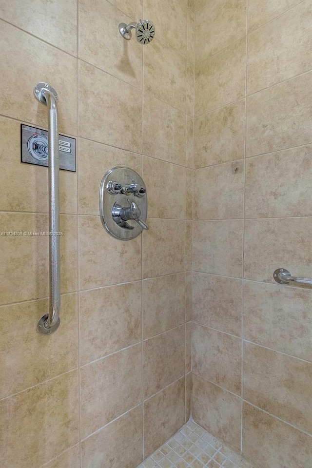 bathroom with tiled shower