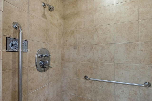 interior details with a tile shower