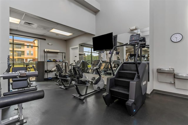 gym with a paneled ceiling