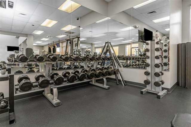 gym with a paneled ceiling