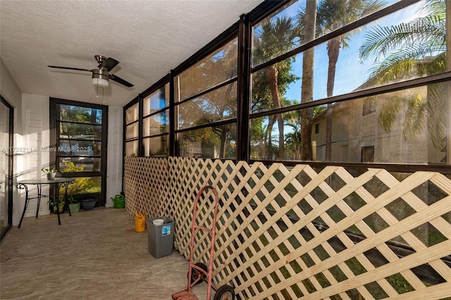 sunroom / solarium featuring ceiling fan