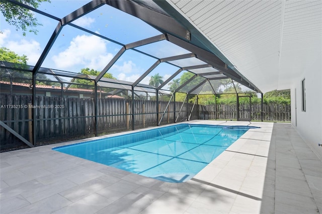 view of pool featuring a patio area and glass enclosure