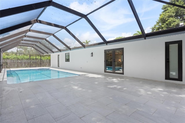 view of swimming pool with a patio area and glass enclosure