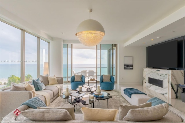 living room with expansive windows and a premium fireplace