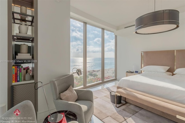 bedroom with a water view and light tile patterned floors