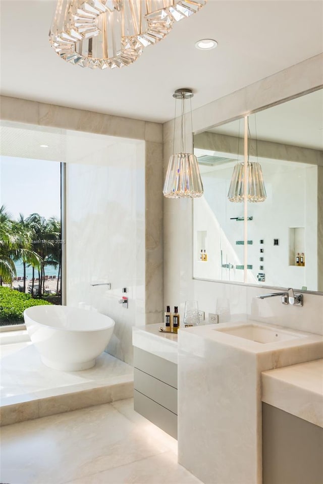 bathroom featuring vanity and a tub