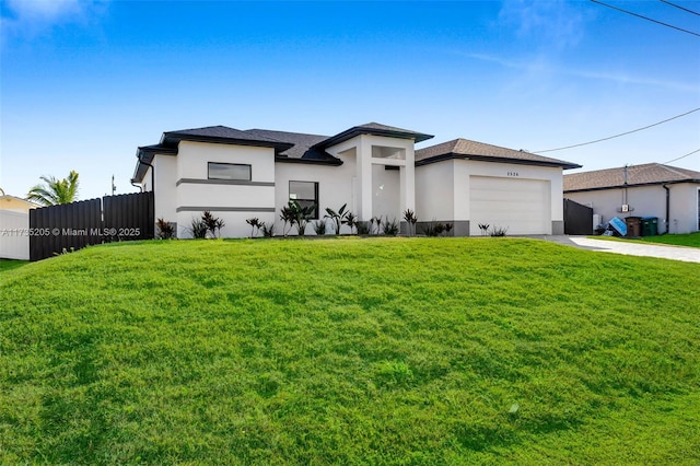 view of front of house featuring a garage and a front lawn