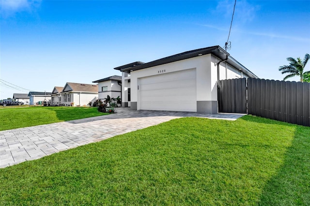 view of front of property featuring a garage and a front lawn