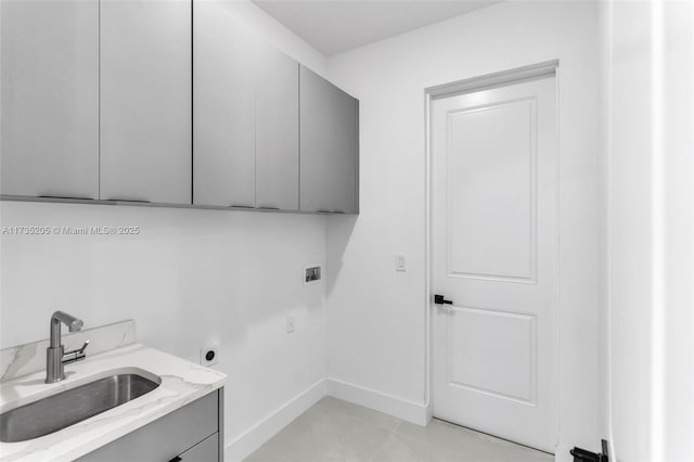 laundry area featuring electric dryer hookup, sink, hookup for a washing machine, and cabinets