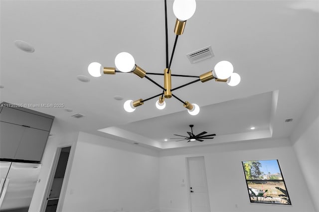 details featuring ceiling fan and a raised ceiling