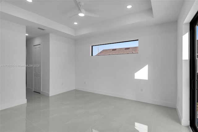 unfurnished room with a tray ceiling