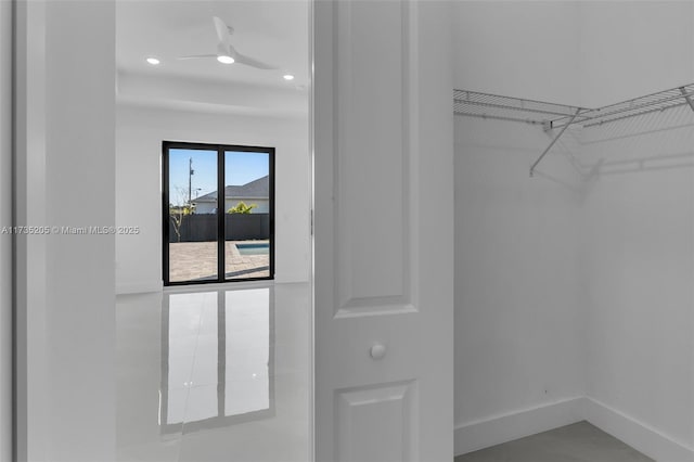 walk in closet featuring ceiling fan