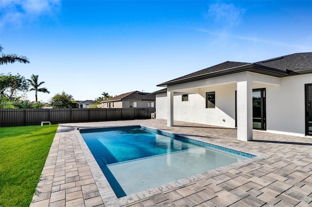 view of swimming pool with a yard and a patio